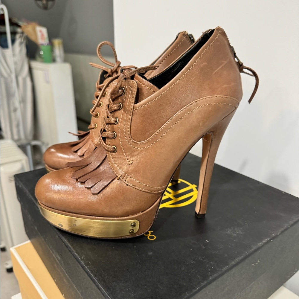Tall platform heals.  Barley worn